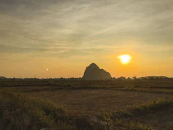 Scenic view of field against sky during sunset