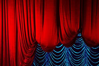 Close-up of red curtains at auditorium