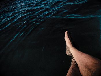 Low section of man relaxing in water