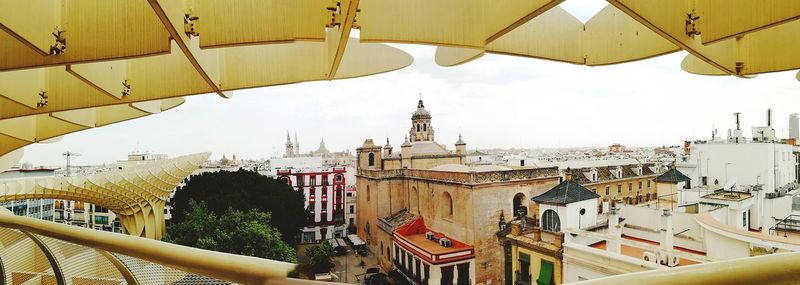 Panoramic view of buildings in city against sky