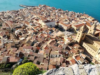 High angle view of houses and sea against sky