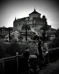 Rear view of people in temple against clear sky