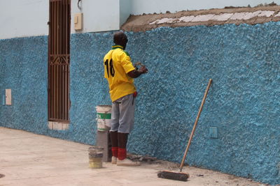 Rear view of man walking on floor