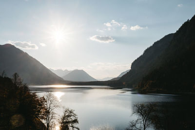 Scenic view of lake and mountains against sky