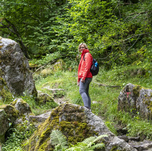 Portrait of young man standing on rock