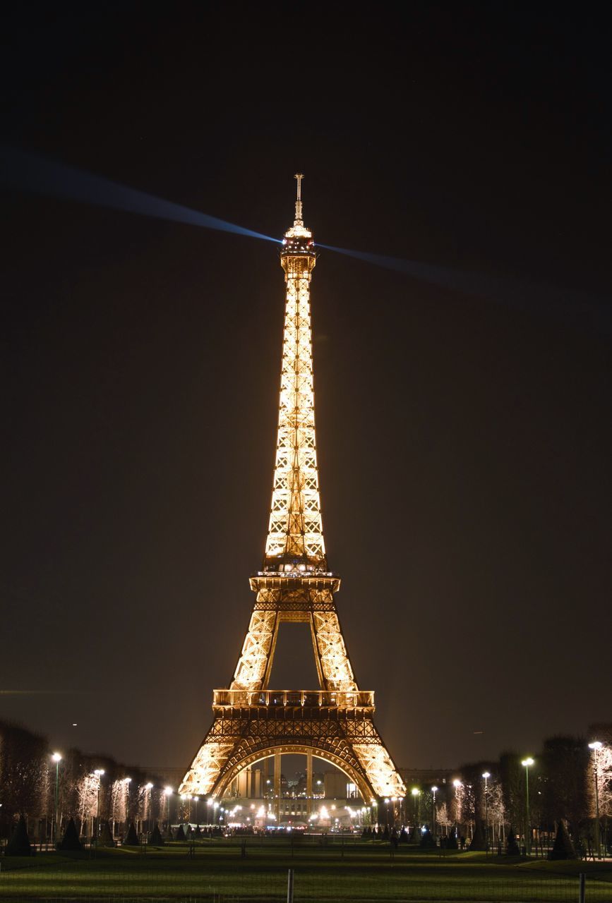 night, eiffel tower, illuminated, travel destinations, international landmark, famous place, built structure, tourism, architecture, travel, capital cities, tower, tall - high, clear sky, low angle view, sky, metal, culture, copy space, outdoors