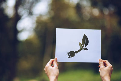 Midsection of person holding heart shape made from plant