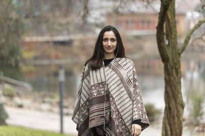 Portrait of smiling young woman standing outdoors