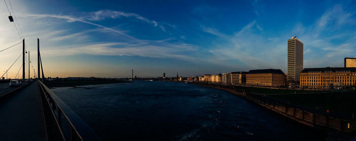 View of bridge over river against cloudy sky