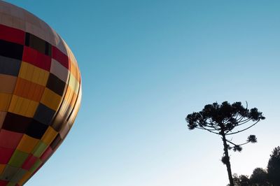 Low angle view of hot air balloon against clear blue sky