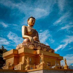 Low angle view of statue against sky