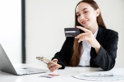 Young woman using mobile phone at office