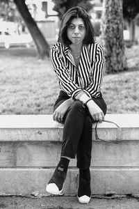 Portrait of young woman sitting on steps