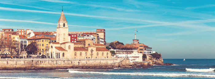 View of buildings by sea