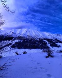 Scenic view of snow covered landscape against sky