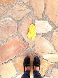 Low section of person standing on tiled floor