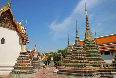 Full length of woman looking at temple against sky