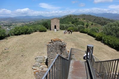 View of castle on mountain against cloudy sky