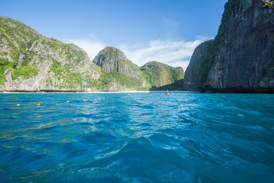 Scenic view of sea and mountains against sky