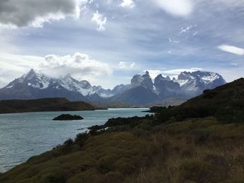 Scenic view of lake against cloudy sky