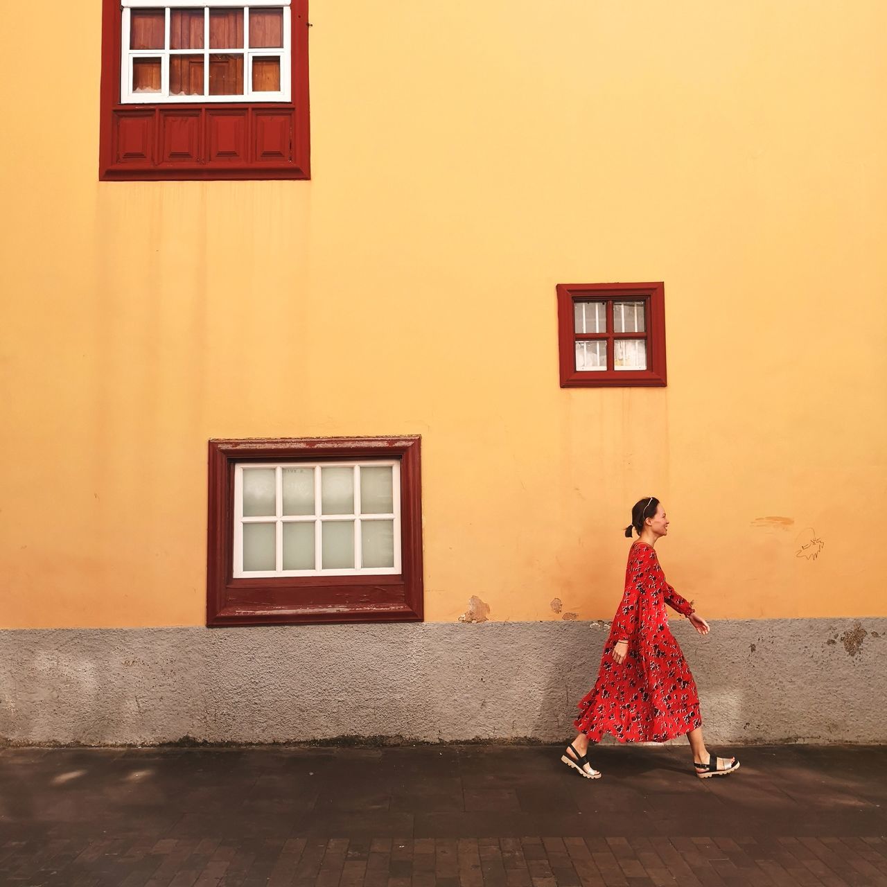 one person, women, wall - building feature, architecture, real people, built structure, clothing, red, adult, lifestyles, building exterior, full length, young women, fashion, young adult, building, orange color, dress, standing, outdoors