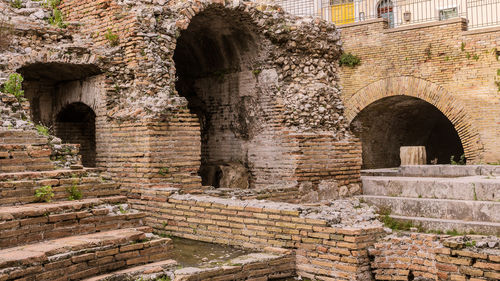 A detail of the ruins of odeon, the ancient greek theater of taormina, in sicily, landscape cut.