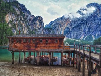 Built structure by lake against sky