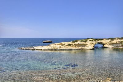 Scenic view of sea against clear blue sky