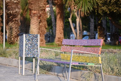Empty chairs and table in park