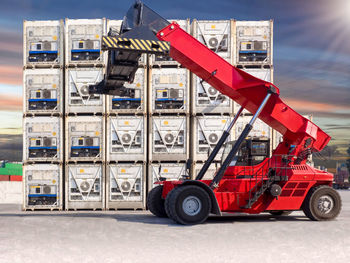 Red vehicle by control panel outdoors