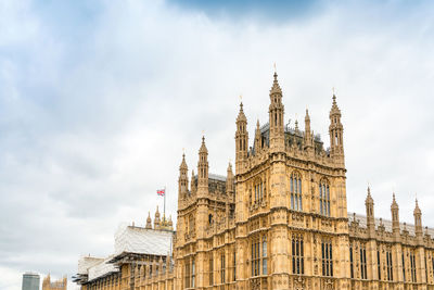 Low angle view of palace of westminster against sky