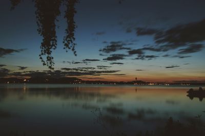 Scenic view of lake against sky at sunset