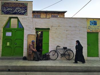 View of woman standing by building