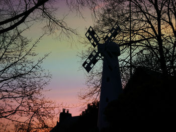 Low angle view of silhouette trees against sky