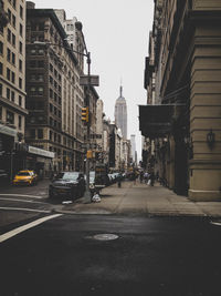 City street amidst buildings against sky