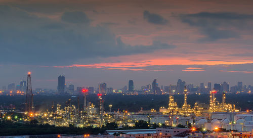 Illuminated cityscape against sky at night