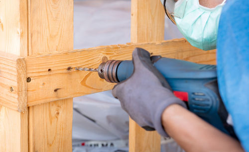 Midsection of man working in workshop