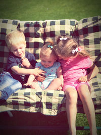 High angle view of friends sitting outdoors