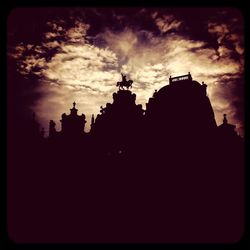 Low angle view of built structure against cloudy sky