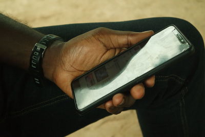 Close-up of man using mobile phone