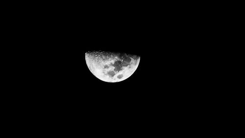 Low angle view of moon against dark sky