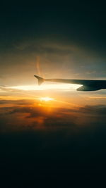 Cropped image of airplane flying over sea