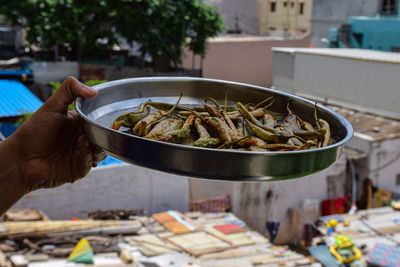 Person holding food at market stall