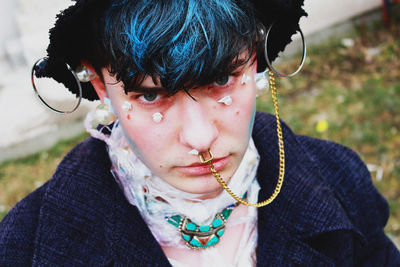 Close-up portrait of young man with pierced nose