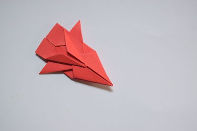 High angle view of red paper on white background