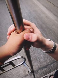 High angle view of couple holding pole in city