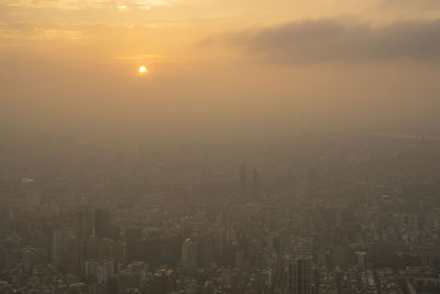 High angle view of illuminated cityscape against sky during sunset