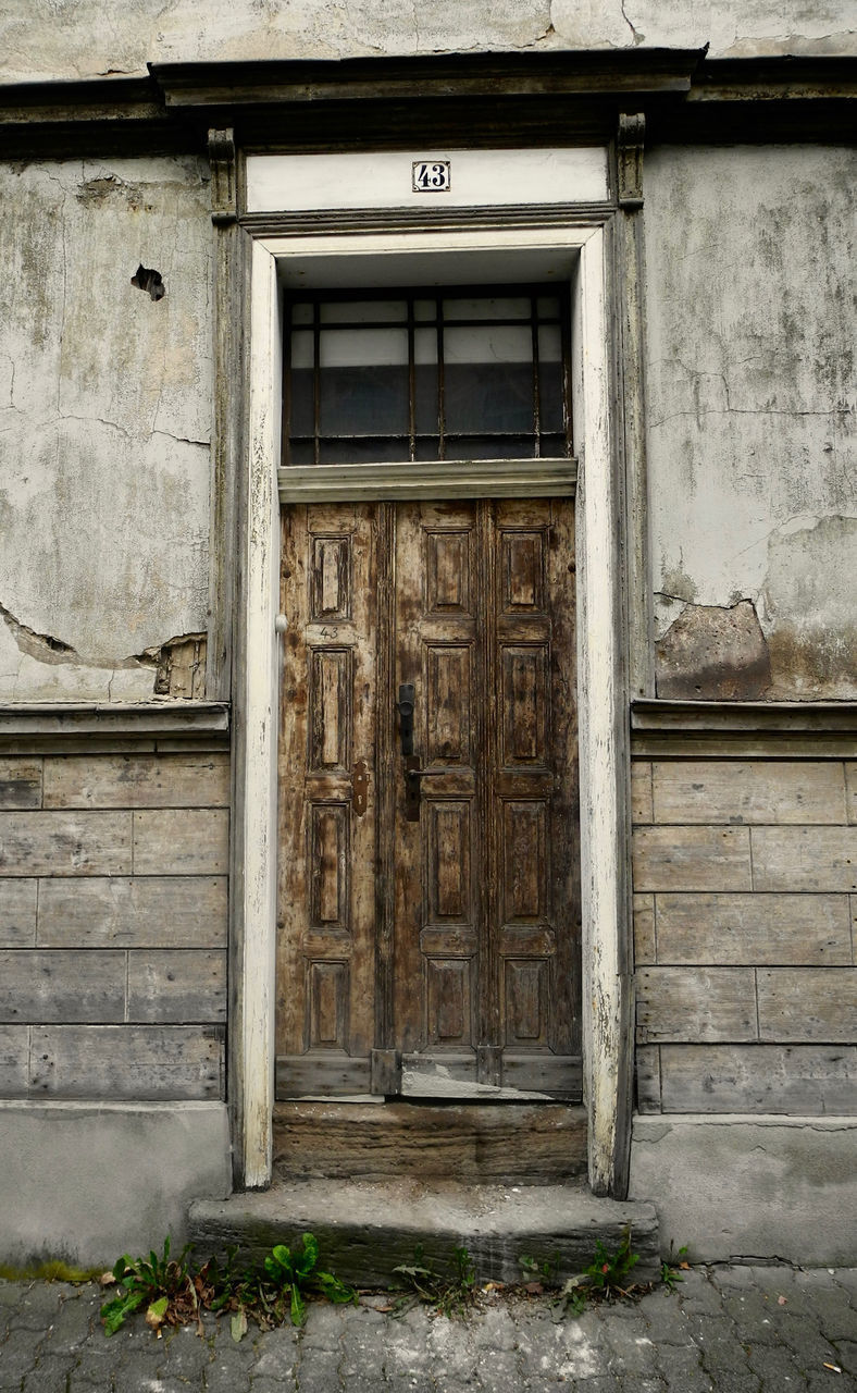 CLOSED DOOR OF ABANDONED HOUSE