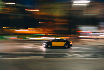 Cars moving on illuminated road at night