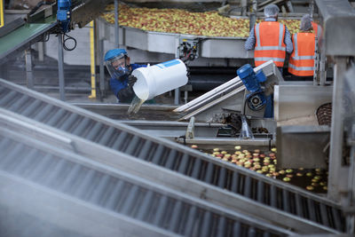 Worker wearing protective mask at apple distribution factory